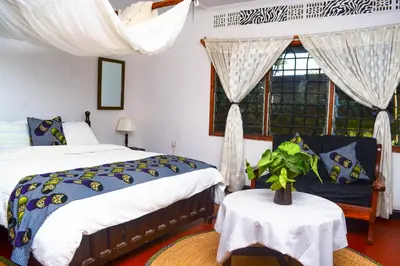a bedroom with two beds and a window at Ethiopian restaurant and lodge in Arusha