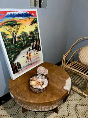 a table with a picture and a bowl on it at Shambani Homestay in Moshi