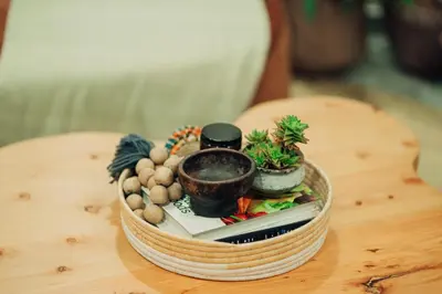 a wooden table with a basket of plants on it at Hatua Dahlia Home in Arusha