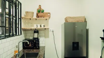 a kitchen with a green refrigerator and a stove at Hatua Dahlia Home in Arusha