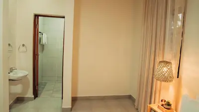 a bathroom with a shower and a sink at Hatua Dahlia Home in Arusha