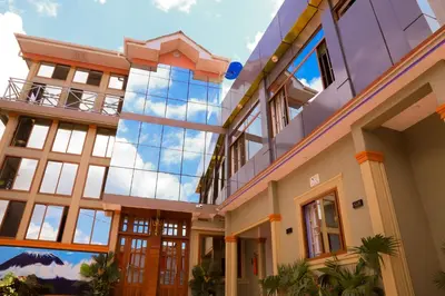 a large building with a lot of windows at River House Lodge International in Arusha