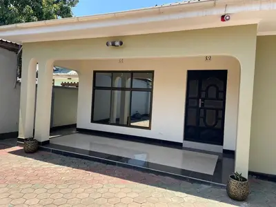 a house with a door and a patio at Emmalanta Safaris House in Arusha