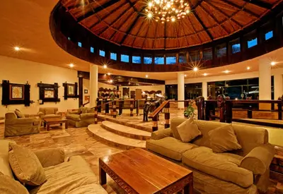 a large living room with couches and a large ceiling at Tarangire Sopa Lodge in Madege