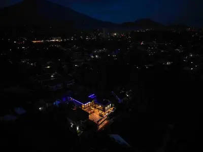 a view of a city at night with lights at River House Lodge in Arusha