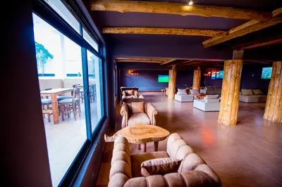 a living room with couches and a table in a room at Ritzy Arcadia Cottages in Arusha