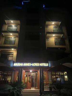 a building with a sign that reads anaemia embassy acres hotel at Acres Hotels in Arusha
