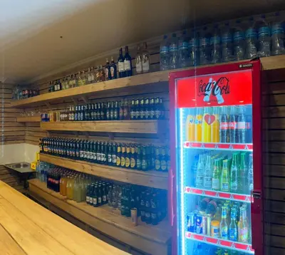 a vending machine filled with lots of bottles of soda at Acres Hotels in Arusha
