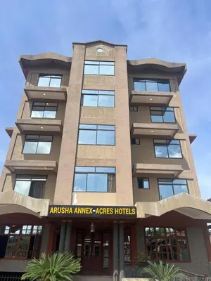 a tall building with an australian embassy aids hotel at Acres Hotels in Arusha
