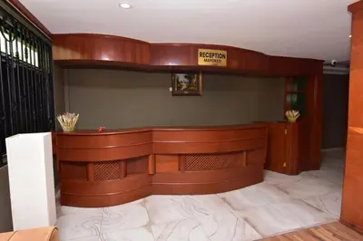 a court room with a bench with a sign on the wall at Acres Hotels in Arusha