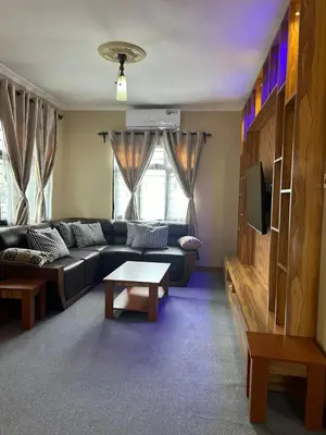a living room with a couch and a table at Modern Standalone house in Themi