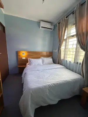 a bedroom with a large white bed with a window at Modern Standalone house in Themi