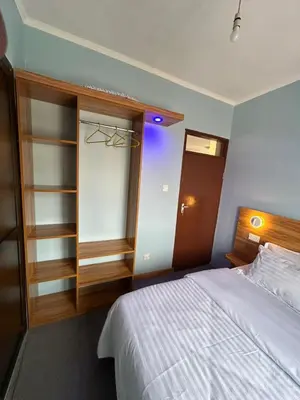 a bedroom with a white bed and a closet at Modern Standalone house in Themi