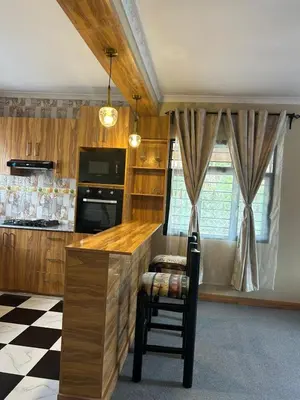 a kitchen with a counter and a chair in a room at Modern Standalone house in Themi