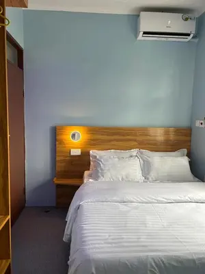 a bedroom with a large bed with a wooden headboard at Modern Standalone house in Themi