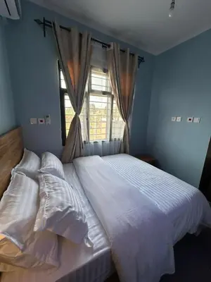a bedroom with a large white bed with a window at Modern Standalone house in Themi