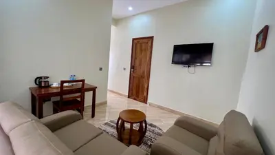 a living room with a couch and a table at Skylark Hotel in Karatu
