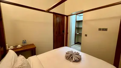 a bedroom with a bed with a bow on it at Skylark Hotel in Karatu