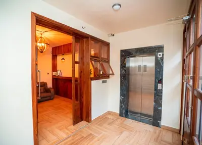 a hallway with a glass door leading to a kitchen at Skylark Hotel in Karatu