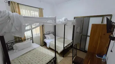 a bedroom with two bunk beds and a window at Arusha Centre Rooms in Arusha