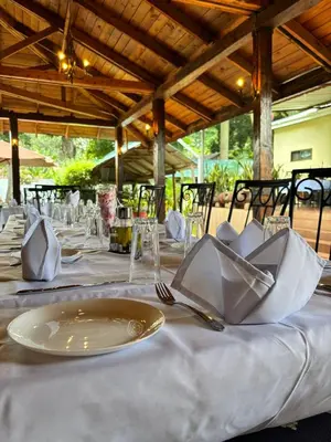 a table with white plates and napkins on it at Arusha Centre Rooms in Arusha