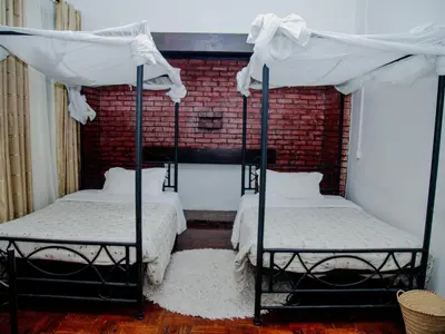 two bunk beds in a room with a brick wall at Arusha Centre Rooms in Arusha
