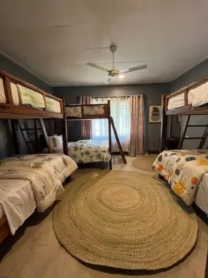 a bedroom with two bunk beds and a large rug at Moshi Urban Hostel and Backpackers in Moshi