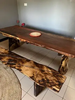 a wooden table with a large piece of wood on it at Moshi Urban Hostel and Backpackers in Moshi