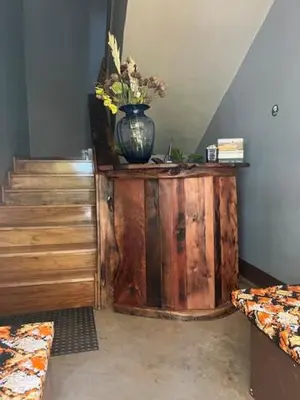 a room with a vase of flowers on a wooden table at Moshi Urban Hostel and Backpackers in Moshi