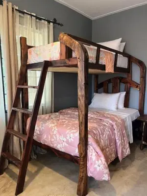 a bedroom with two bunk beds in a room at Moshi Urban Hostel and Backpackers in Moshi