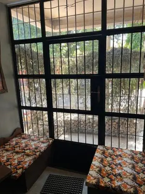 a room with a large window looking out into a room at Moshi Urban Hostel and Backpackers in Moshi