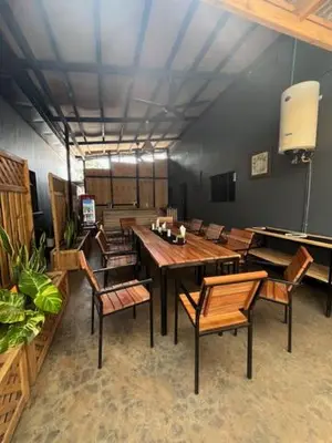 a dining room with a long table and chairs at Moshi Urban Hostel and Backpackers in Moshi