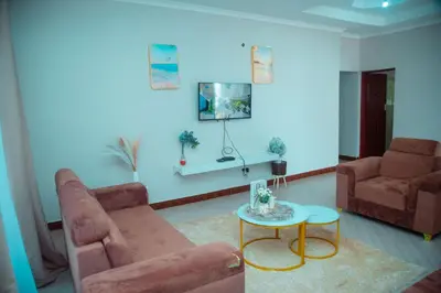 a living room with a couch and a table at Ngorongoro Gateway Homestay in Karatu