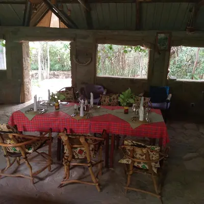 a dining room with a table and some chairs at Tindiga Tented Camp Eyasi in Mangola