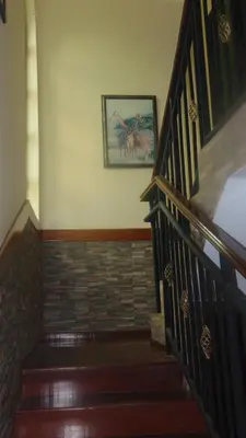 a staircase in a house with a picture on the wall at Njiro Ebenezer Retreat Lodge in Arusha