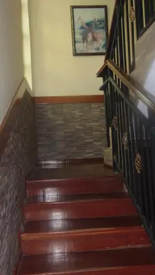 a staircase with wooden steps and a painting on the wall at Njiro Ebenezer Retreat Lodge in Arusha
