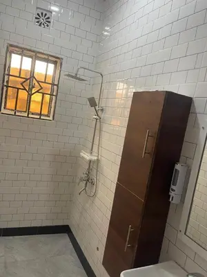 a bathroom with a toilet and a window at Kishongo house in Arusha