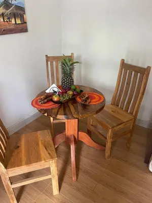 a table with a pineapple and fruit on top of it at Kishongo house in Arusha