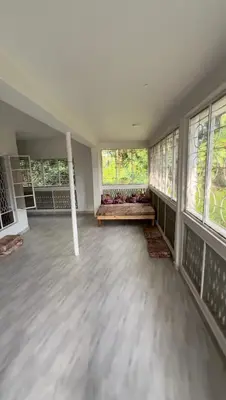 a large empty room with windows and a floor at Malaika Oasis in Moshi