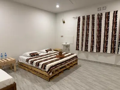 a bedroom with a bed and a large window at Malaika Oasis in Moshi
