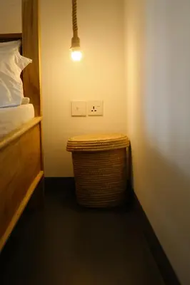 a bedroom with a bed and a wicker trash can at Hakuna in Arusha