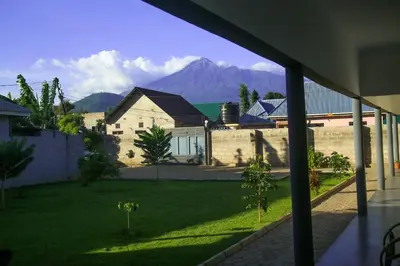 a view of a house with a mountain in the background at Hakuna in Arusha