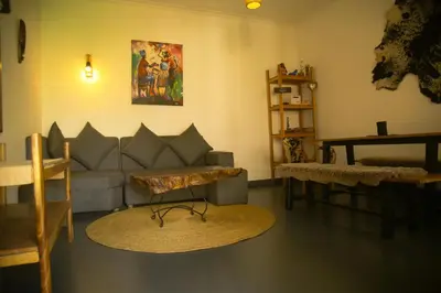a living room with a couch and a table at Hakuna in Arusha