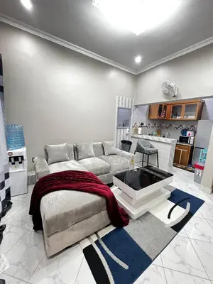 a living room with a couch and a table at Hadraj Clocktower Apartment1 in Arusha