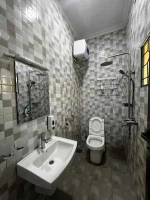 a bathroom with a sink and a toilet at Hadraj Clocktower Apartment1 in Arusha