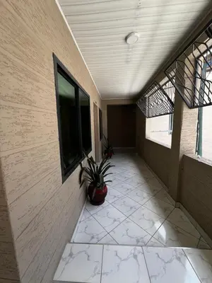 a hallway of a building with a potted plant at Hadraj Clocktower Apartment2 in Arusha