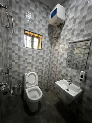 a bathroom with a toilet and a sink at Hadraj Clocktower Apartment2 in Arusha