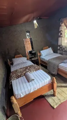 a bedroom with two beds in a room at Alkebulan Farm House in Moshi