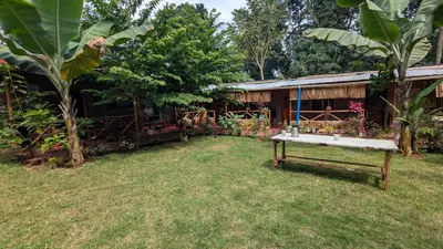 a ping pong table in the yard of a house at Alkebulan Farm House in Moshi