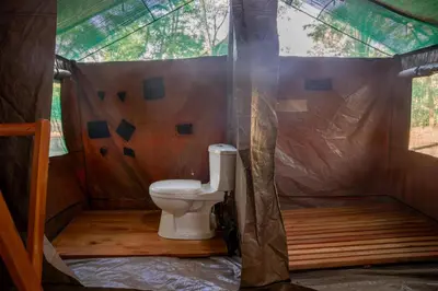 a bathroom with a toilet in a tent at MCF LUXURY Tents in Moshi